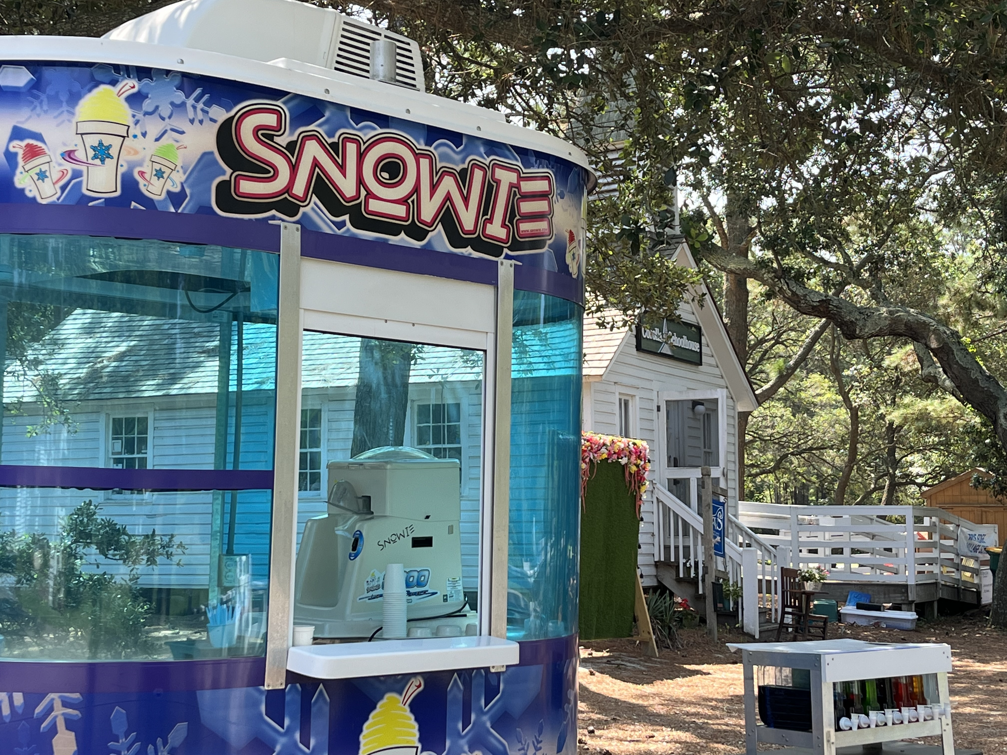 Snowie trailer at festival with self serve flavor station in background