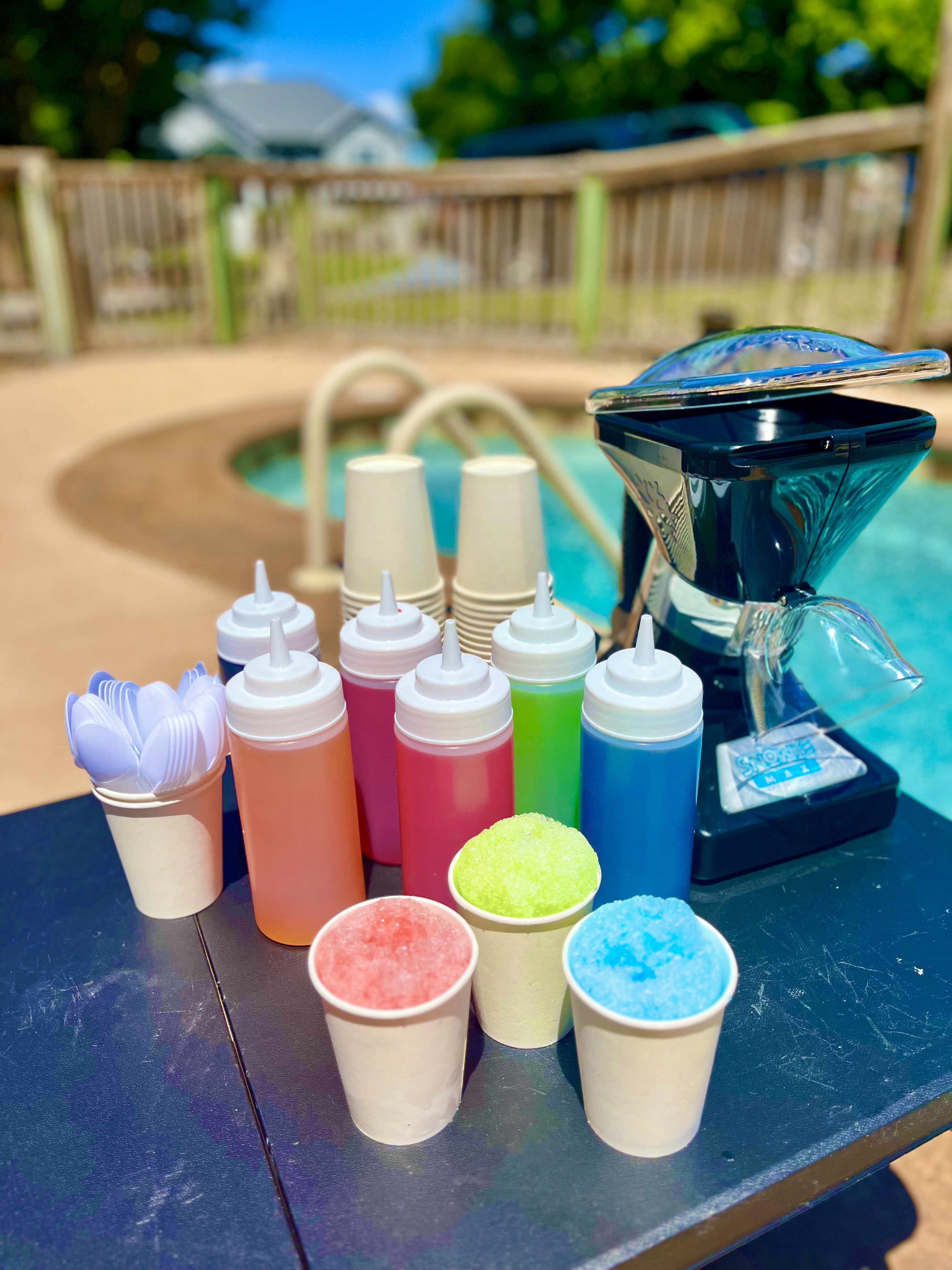 Poolside rental kit with shaver, cups, flavors, and cups of shaved ice at OBX
