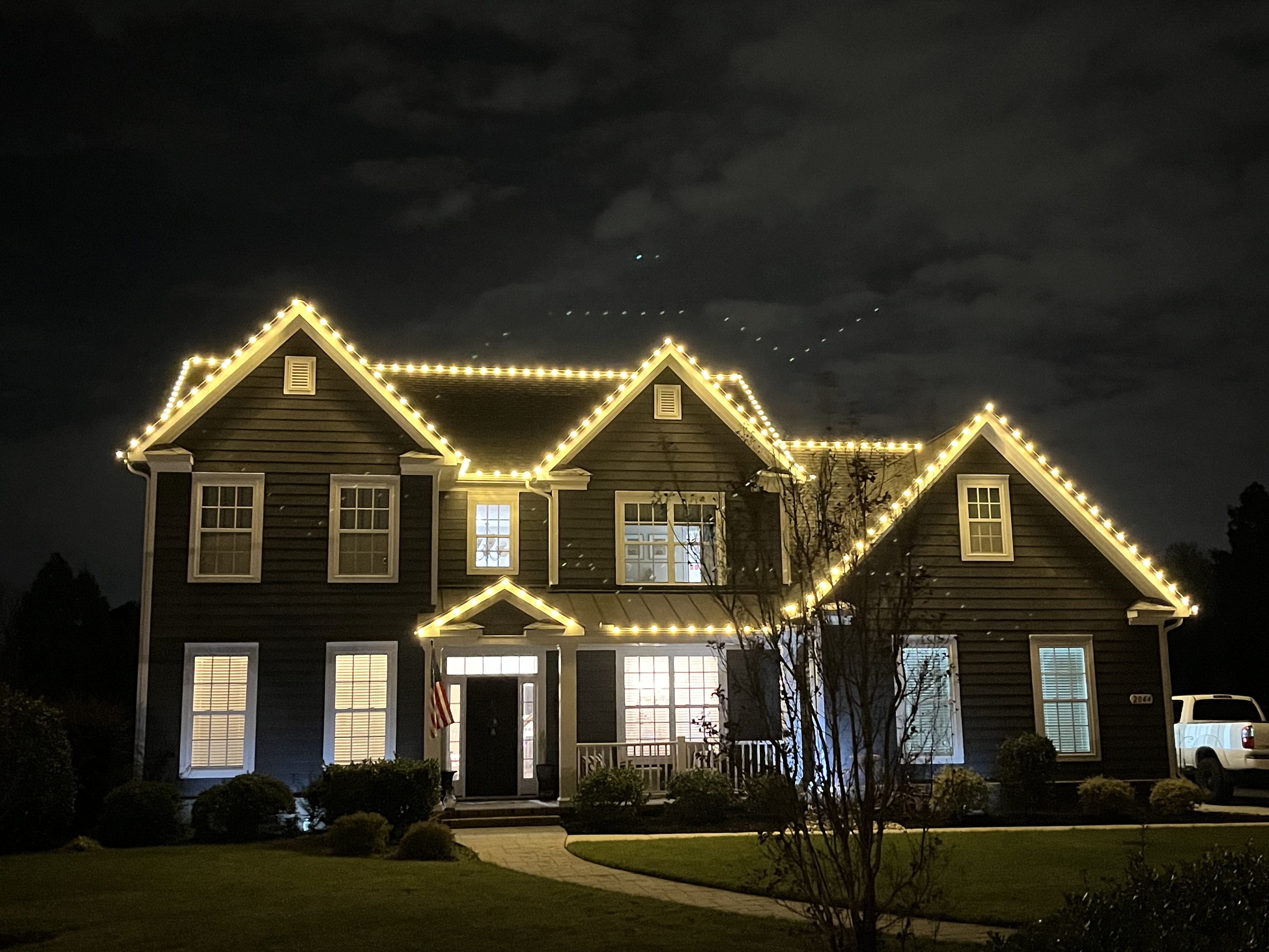 House decorated with Christmas lights at night Newport News