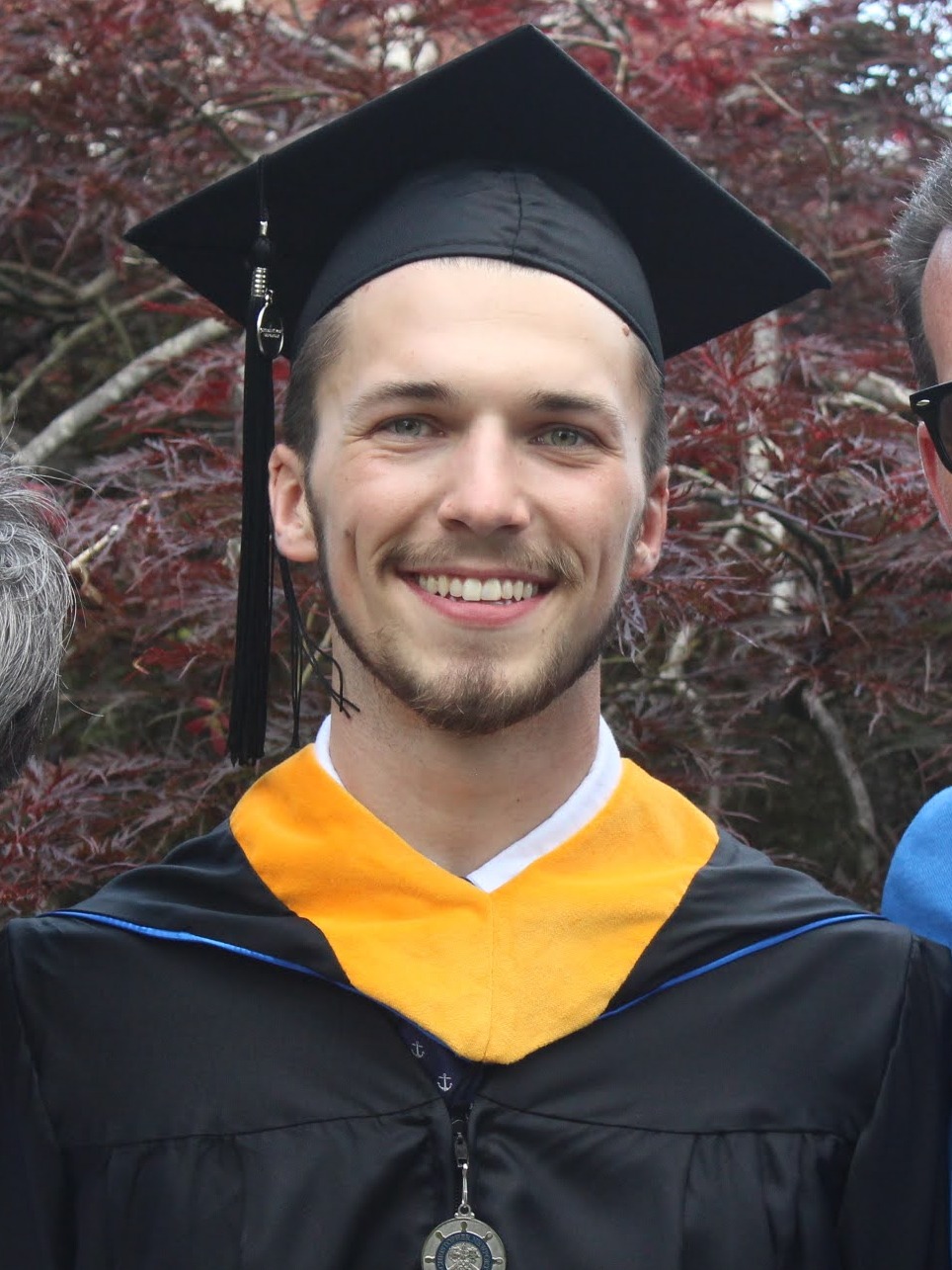 Photo of Matt in cap and gown from Christopher Newport University