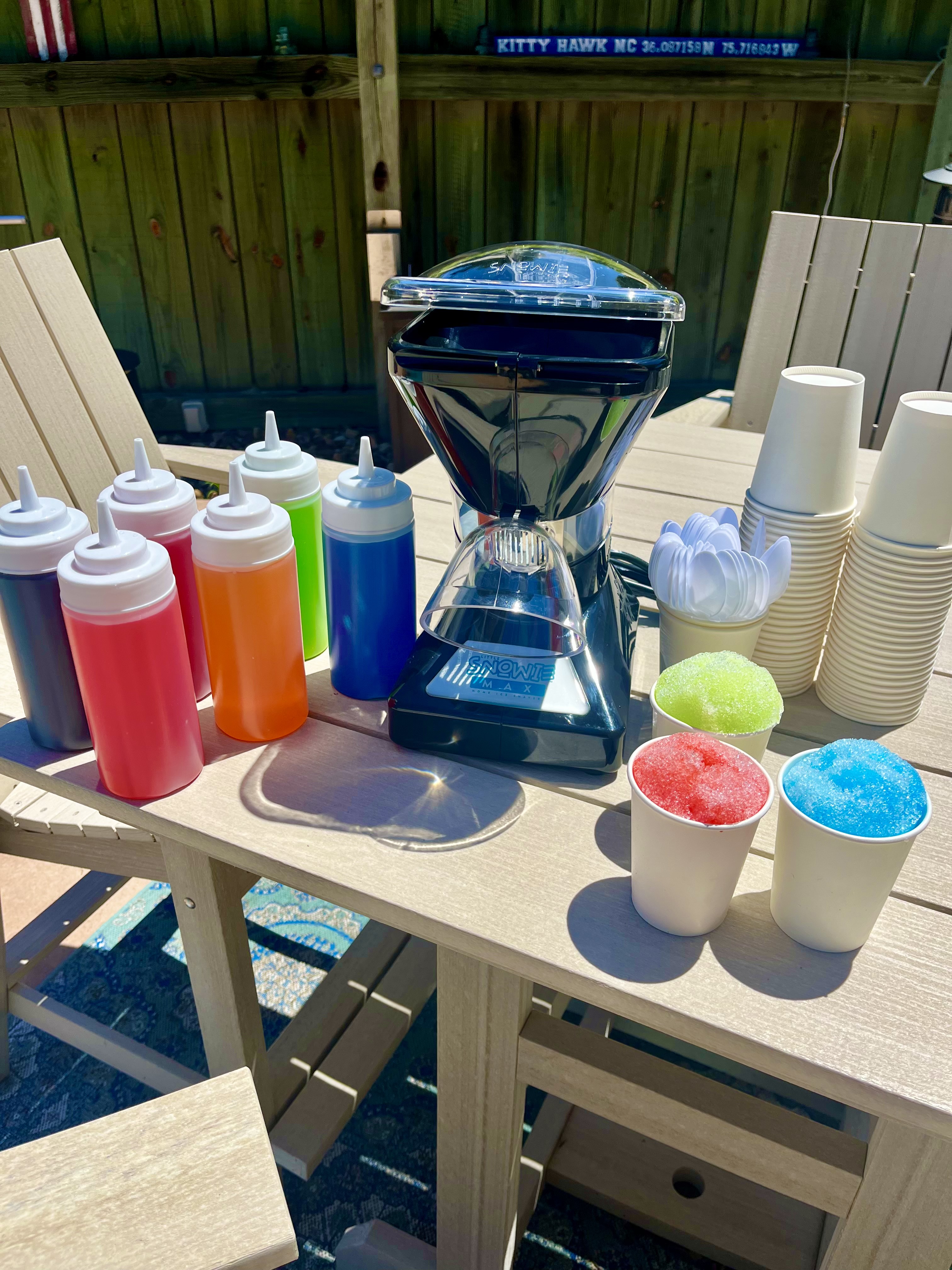 Ice shaver rental kit with flavors and cups of shaved ice