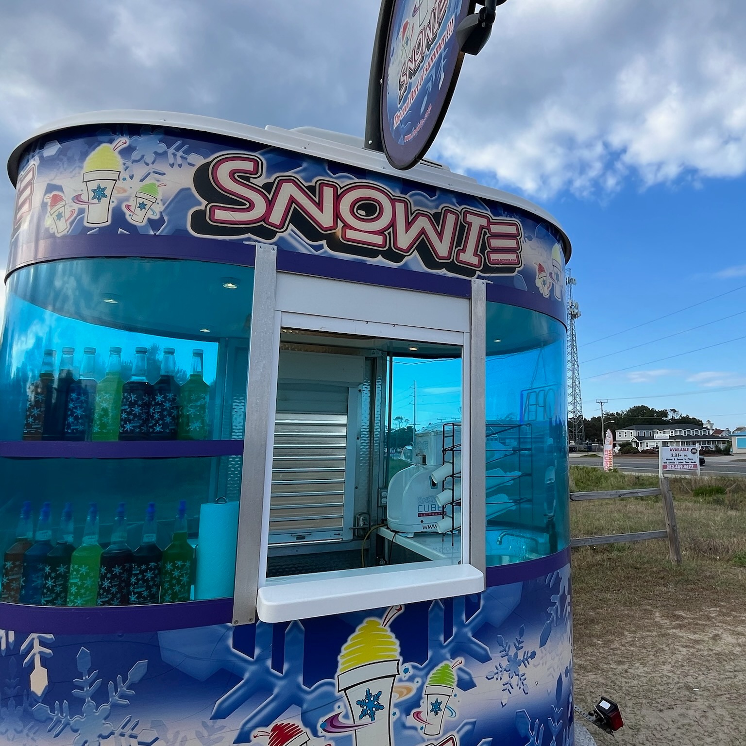 Snowie Shaved Ice trailer with multiple pour bottles of flavor in window